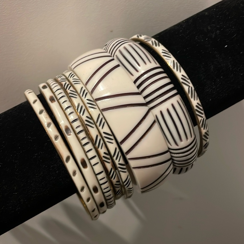 stack of 8 dark blue and white bracelets. brass enamel and plastic